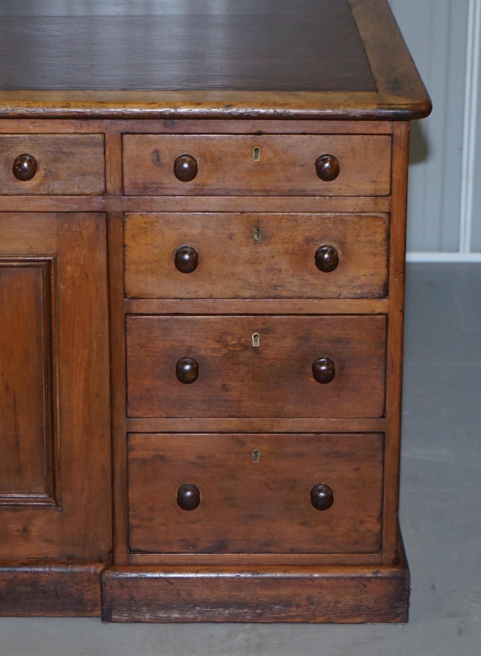 Antique Victorian oak kneehole desk with 18 double-sided drawers.
