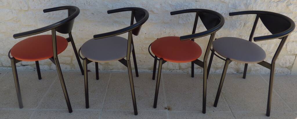 4 gondola-style chairs with a sturdy metal frame and faux leather.