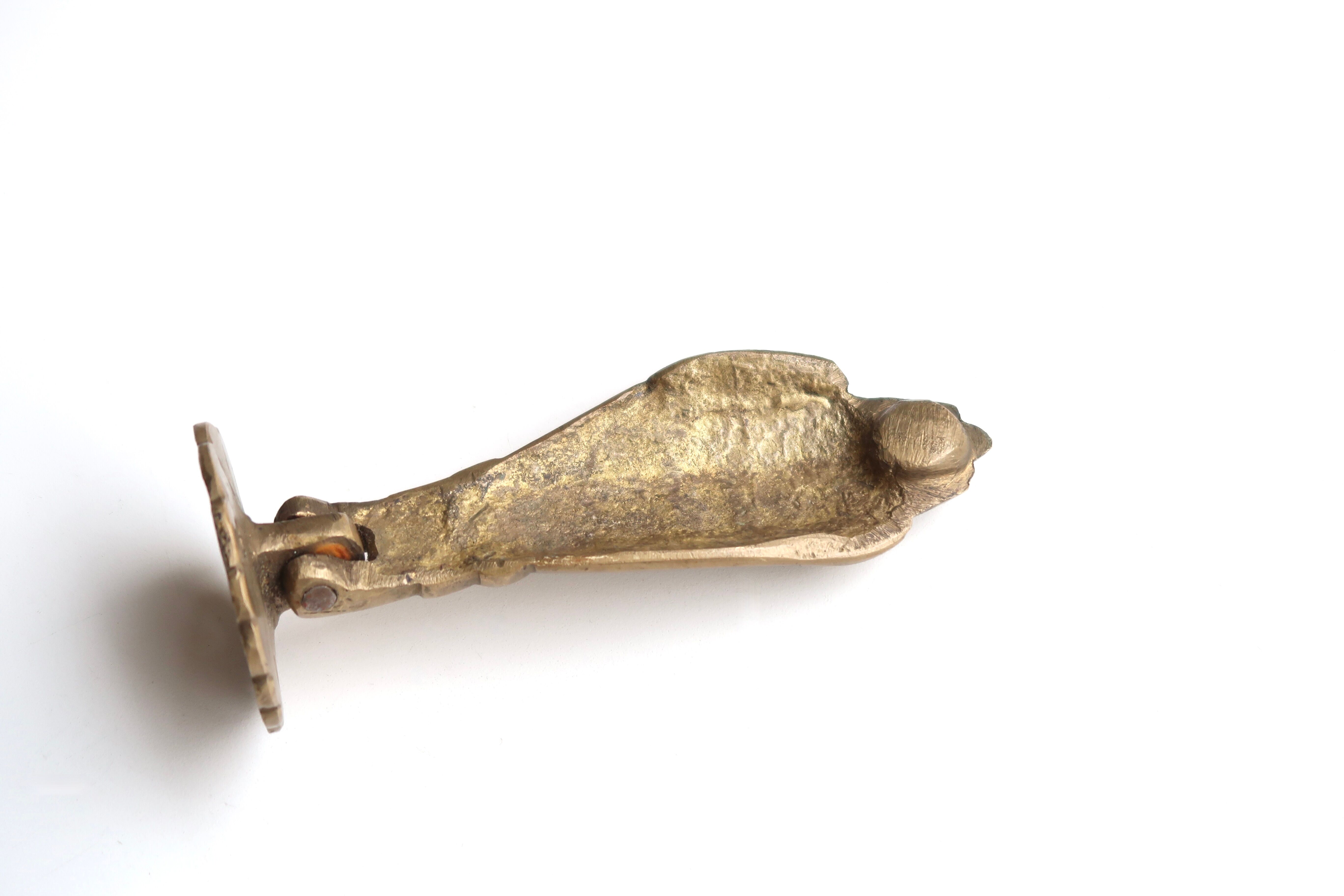 Hand-shaped brass door knocker, 70s