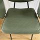 Vintage chair with green imitation leather armrests