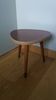 Tripod console table plant stand in the shape of a plectrum.