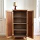 Small oak cabinet with tapered legs.