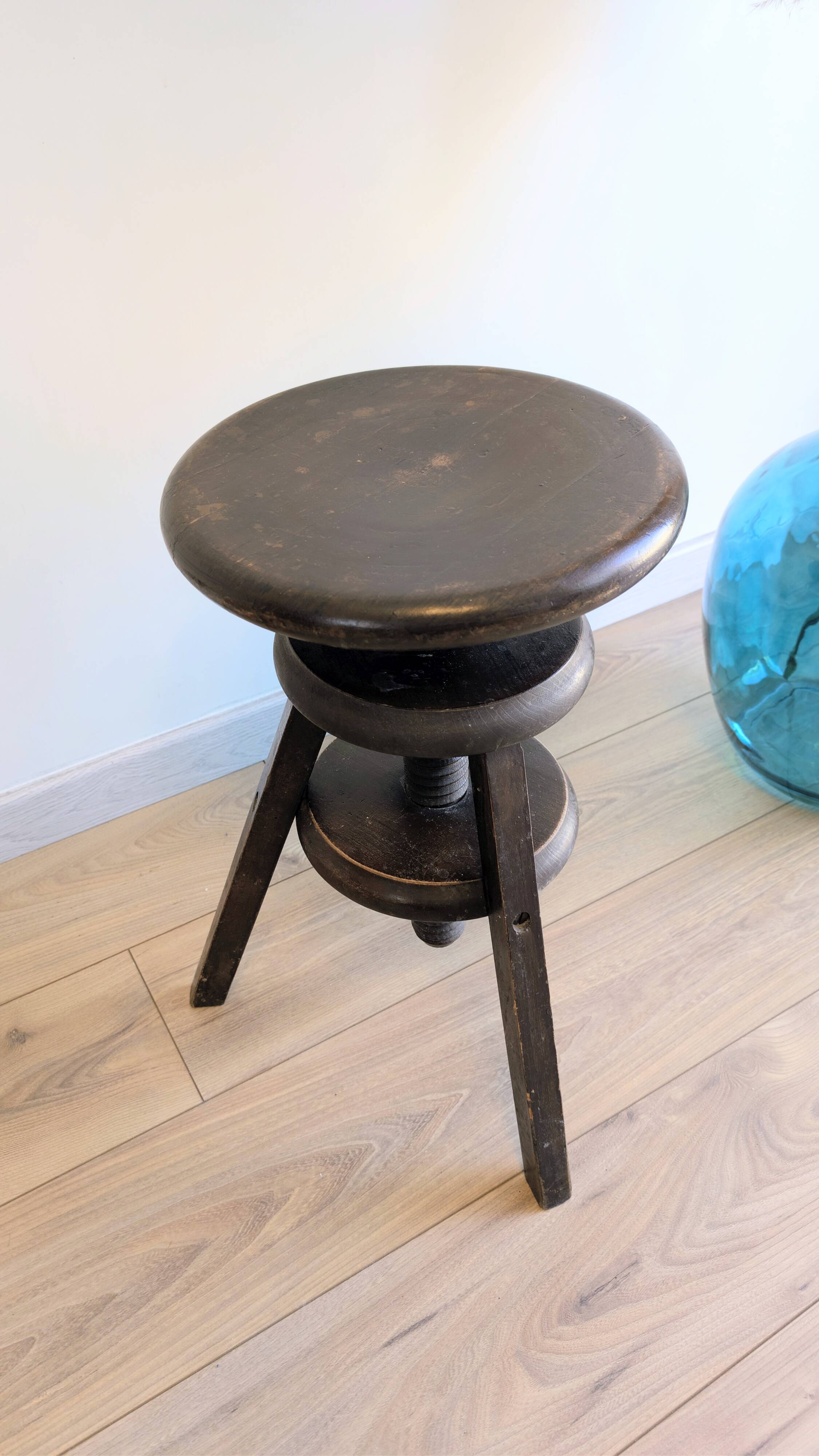 Antique wooden watchmaker's stool with screws, patinated wood.