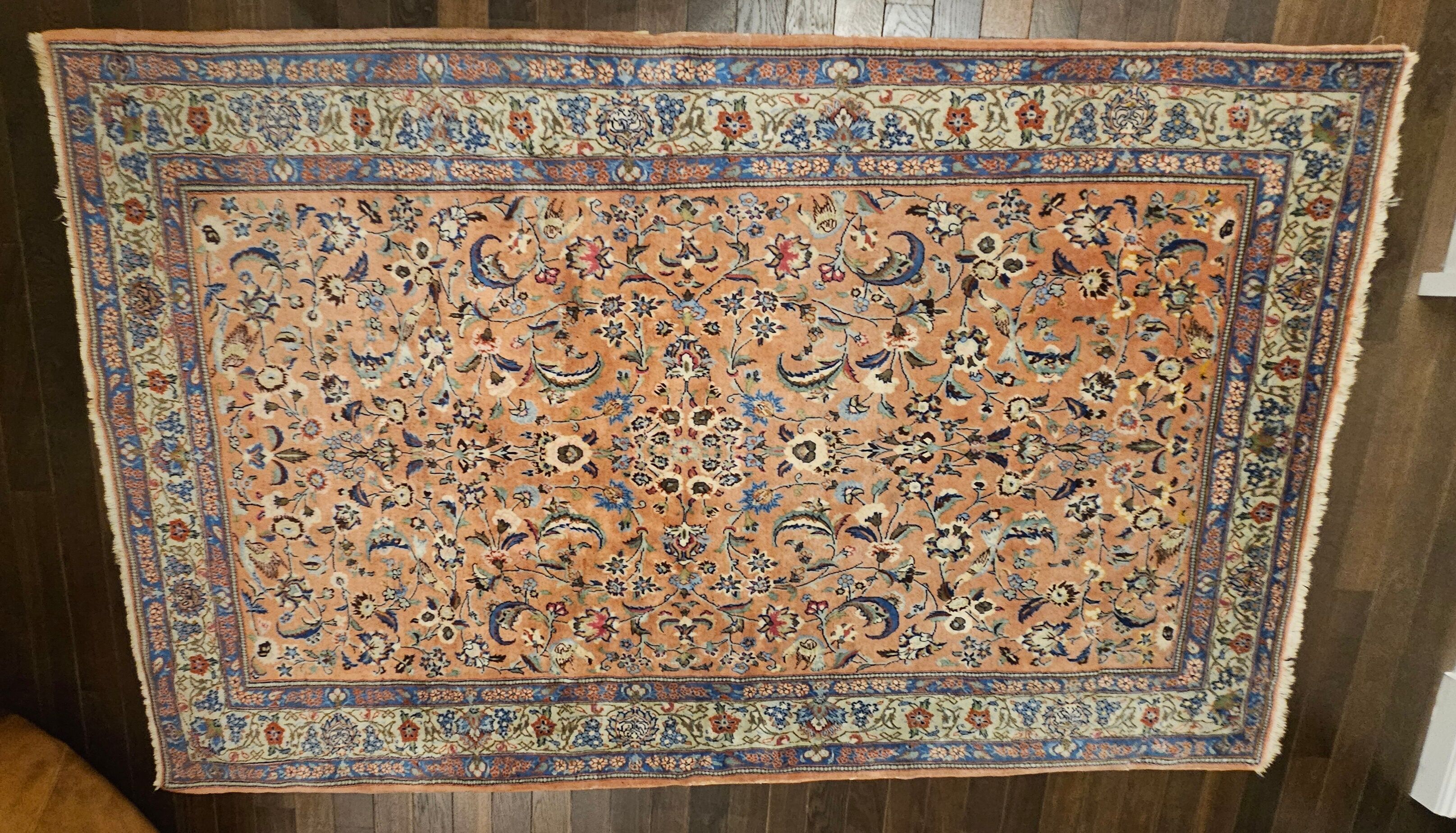 Large wool and silk oriental carpet.