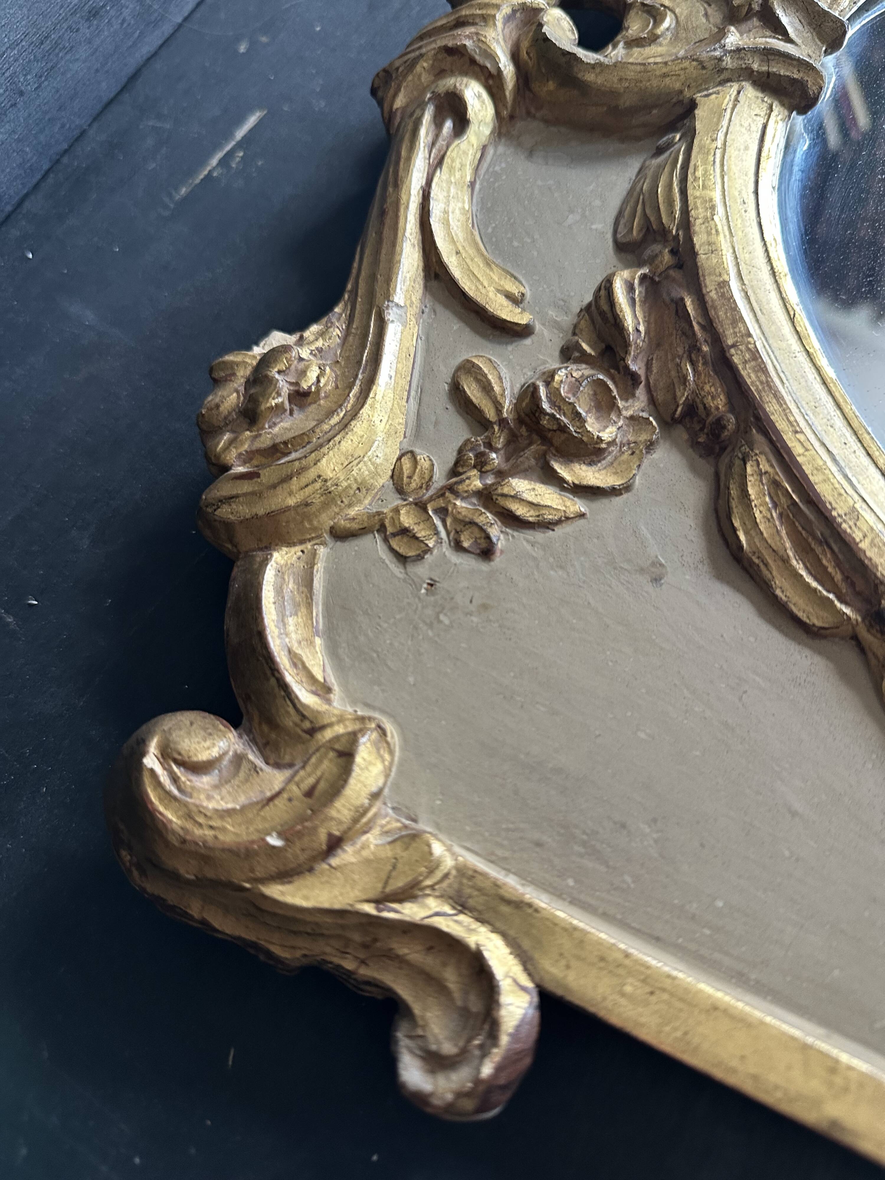 Napoleon III mirror in carved gilded wood, oval mercury glass.