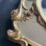 Napoleon III mirror in carved gilded wood, oval mercury glass.