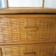 Storage column, wooden bookshelf and woven rattan.