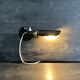 Old black metal and brass wall light, adjustable, 1930s.