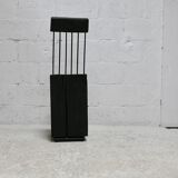 Brutalist chair, black-stained raw wood, steel. Work from the 1970s