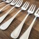 8 mismatched fish forks, silver metal
