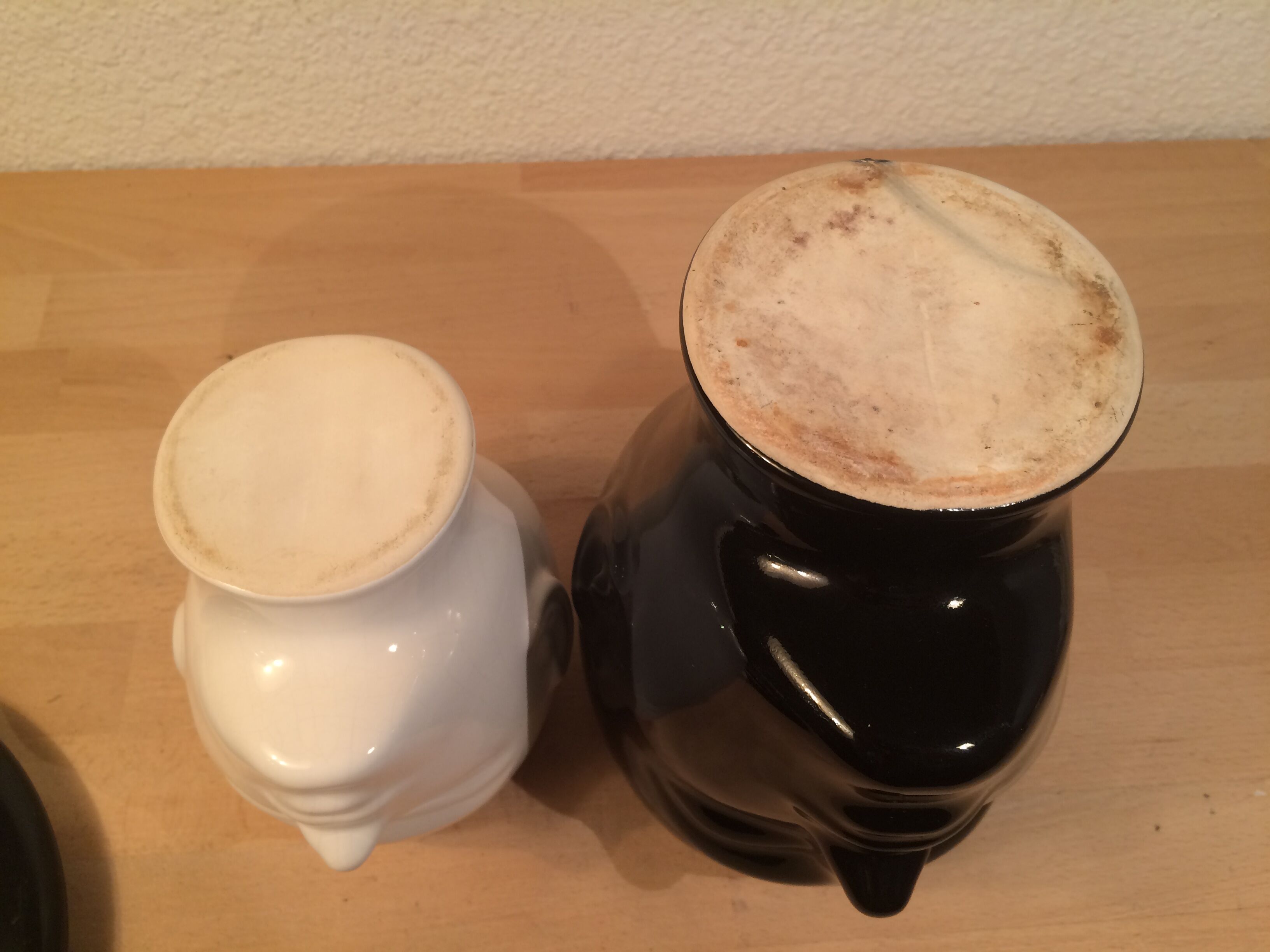 2 black and white ceramic head vases, face