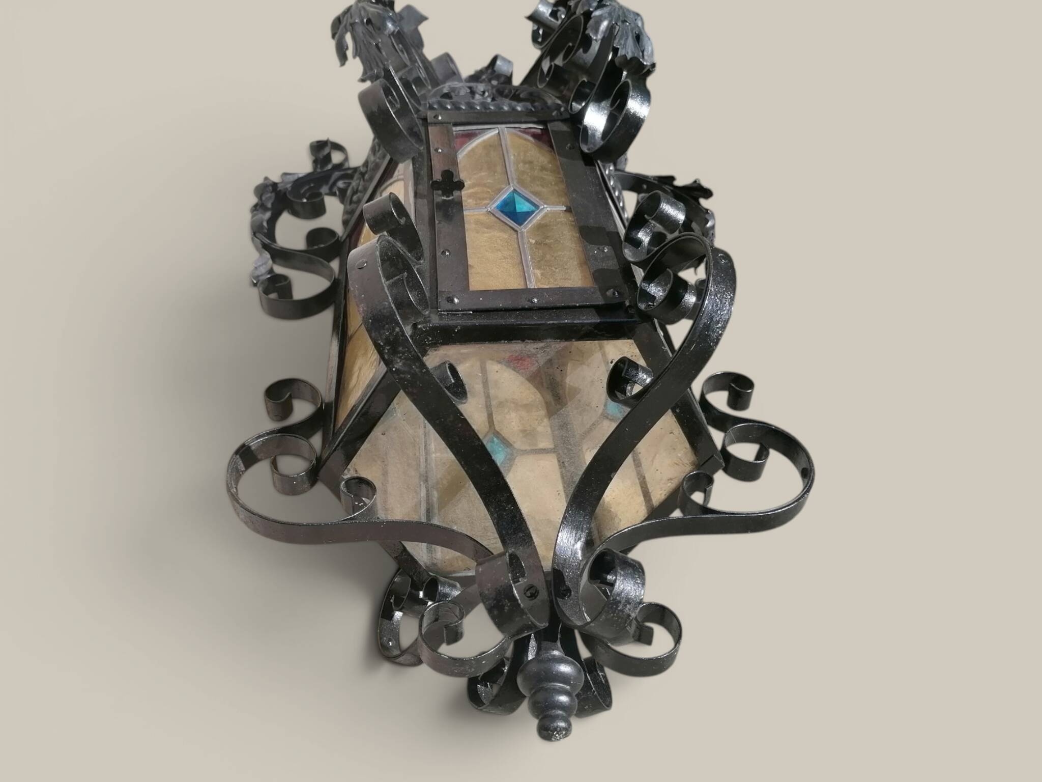 Black wrought iron lantern with stained glass. Medieval, Gothic decoration.