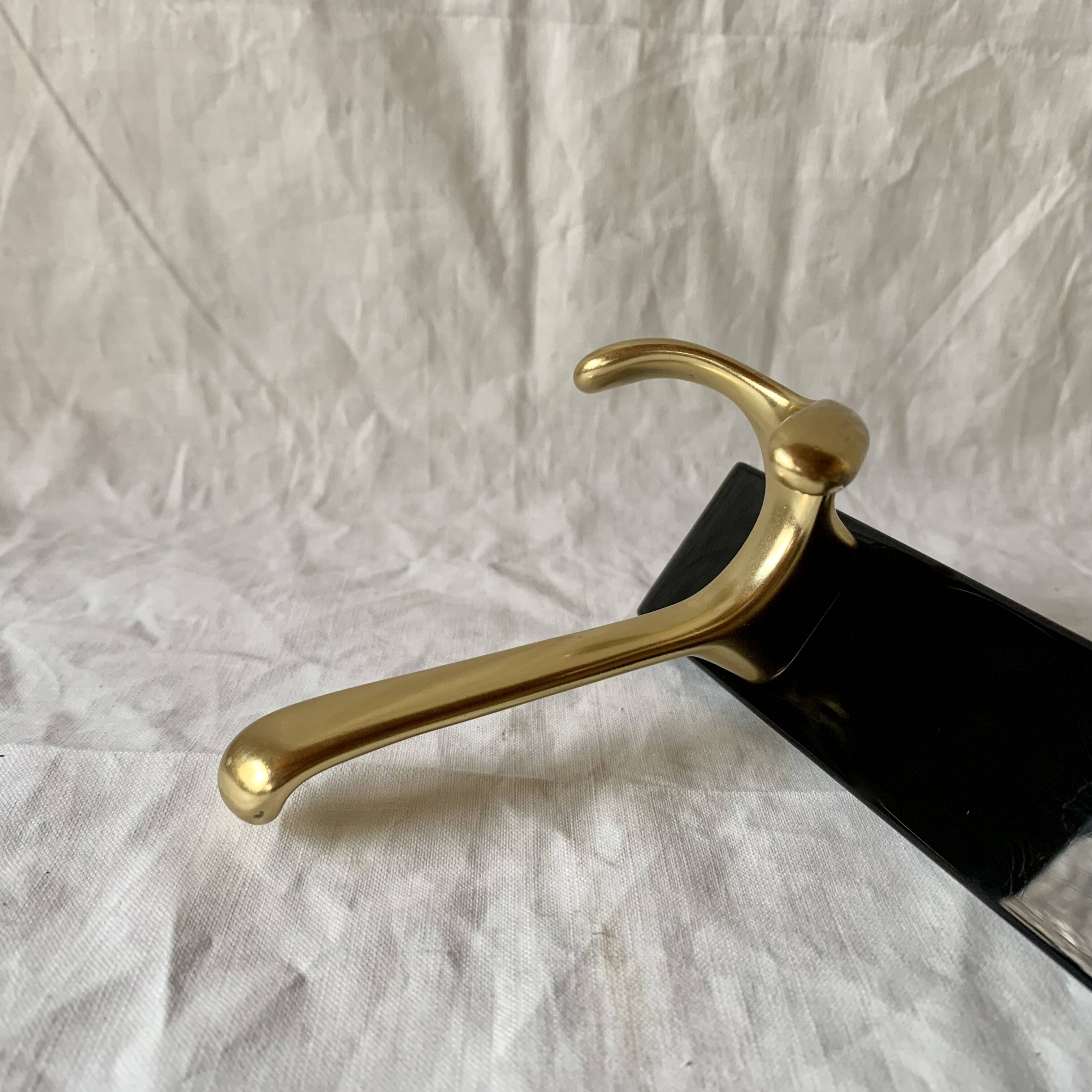 Vintage coat rack in lacquered metal with three golden aluminum hooks
