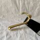 Vintage coat rack in lacquered metal with three golden aluminum hooks