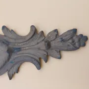 Pair of wall sconces in bronze candle holders with leaf medallion decoration.