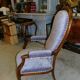 Relaxed Voltaire armchair with walnut racks