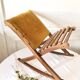 Old wooden rocking footrest with velvet fabric