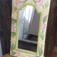 Carved wooden mirror, colourful floral decoration.