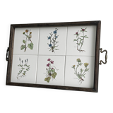 Old wooden plateau with floral tiles