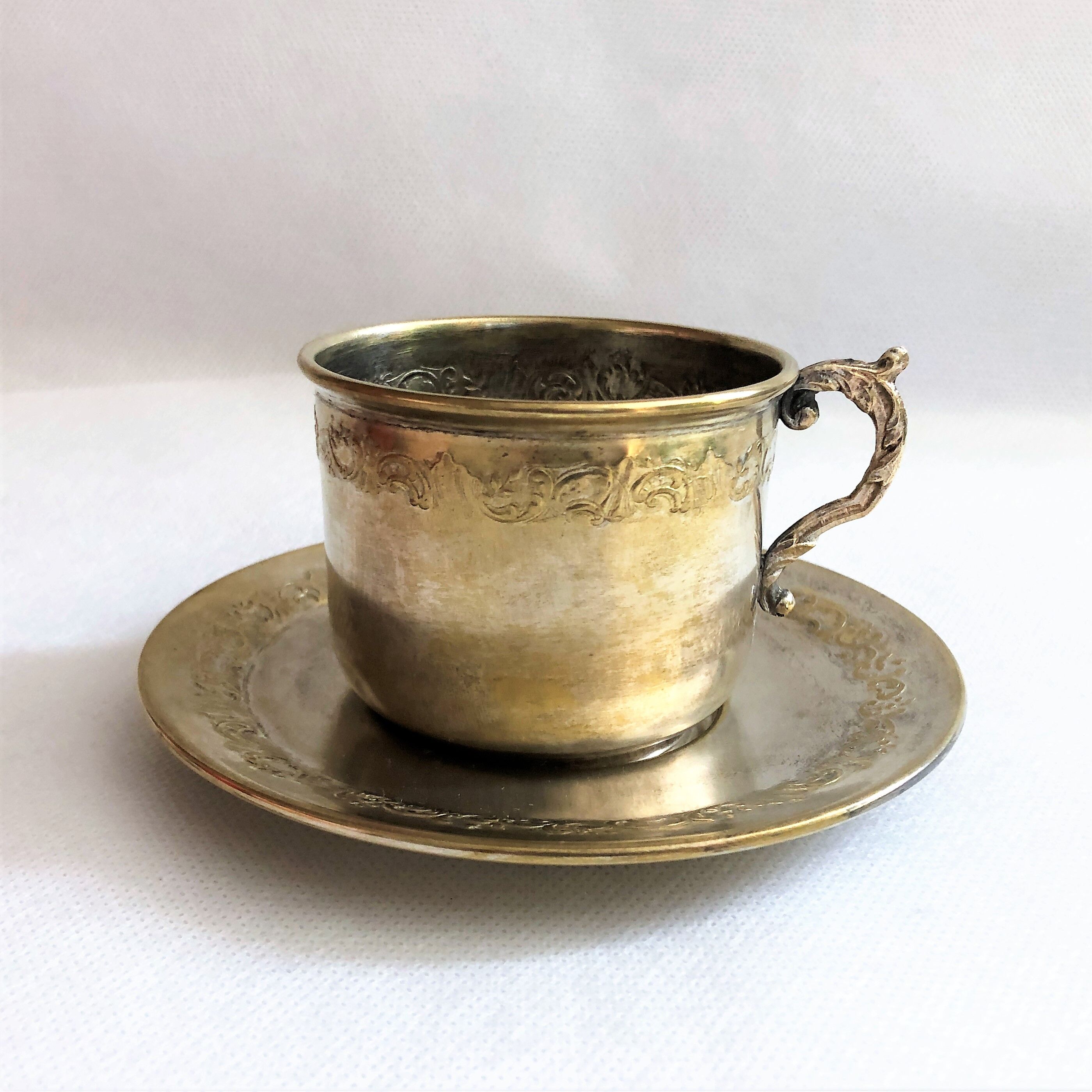 Silver metal cup and saucer