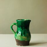 Glazed ceramic pitcher in green and brown by the potter Pierre Roulot.