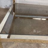 1970s coffee table in brass with a double smoked glass top.