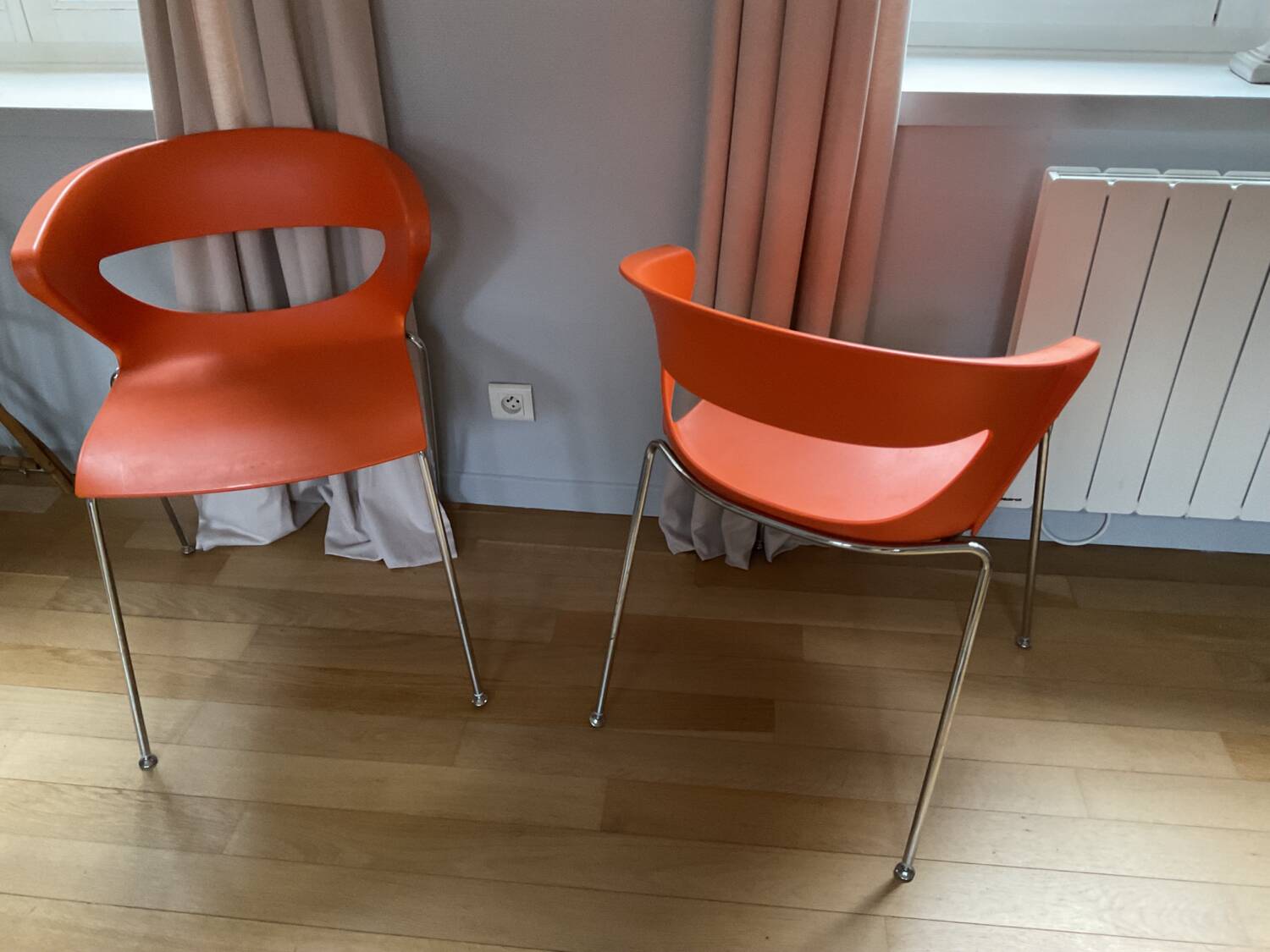 Two orange kicca chairs made in italy tbe