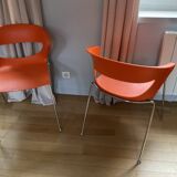 Two orange kicca chairs made in italy tbe