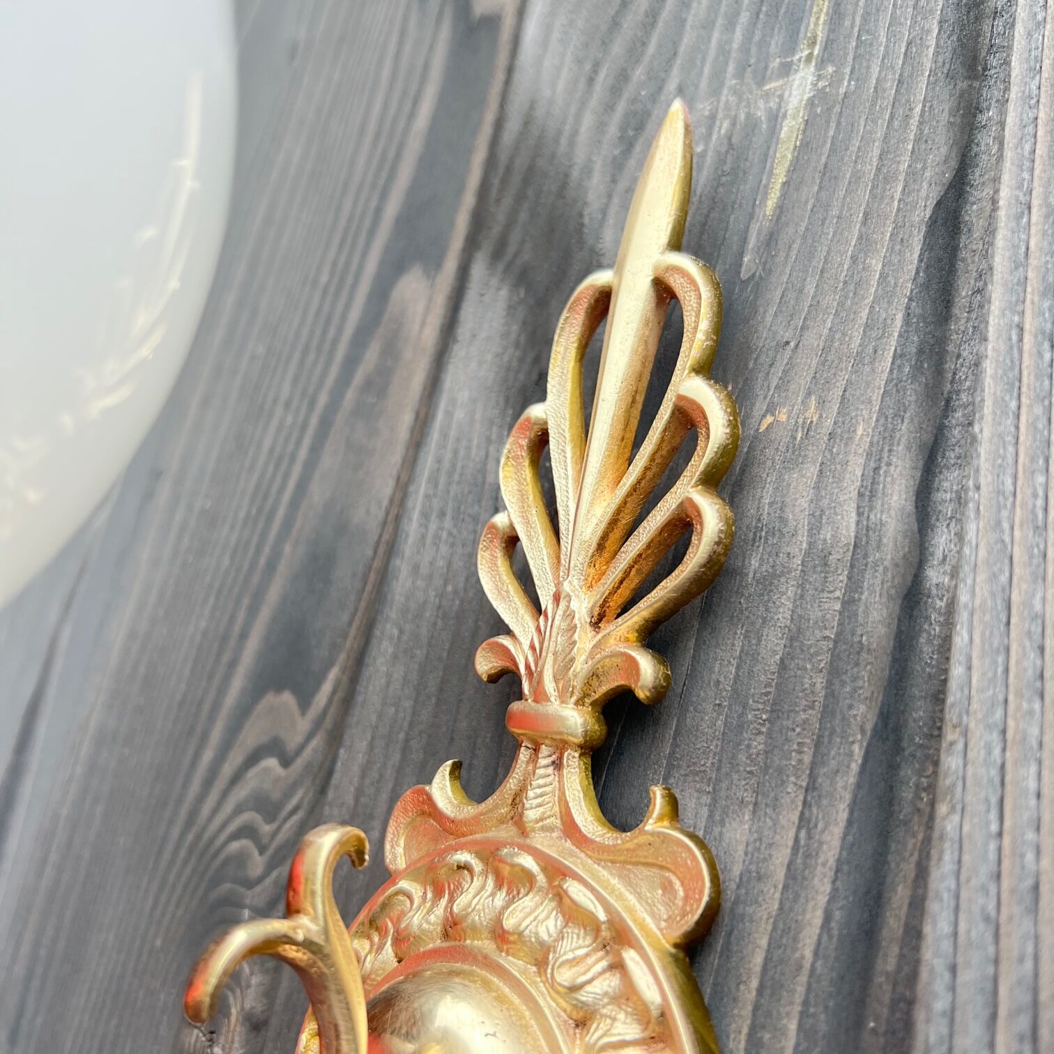 Brass "bird" wall lamp and opal globe