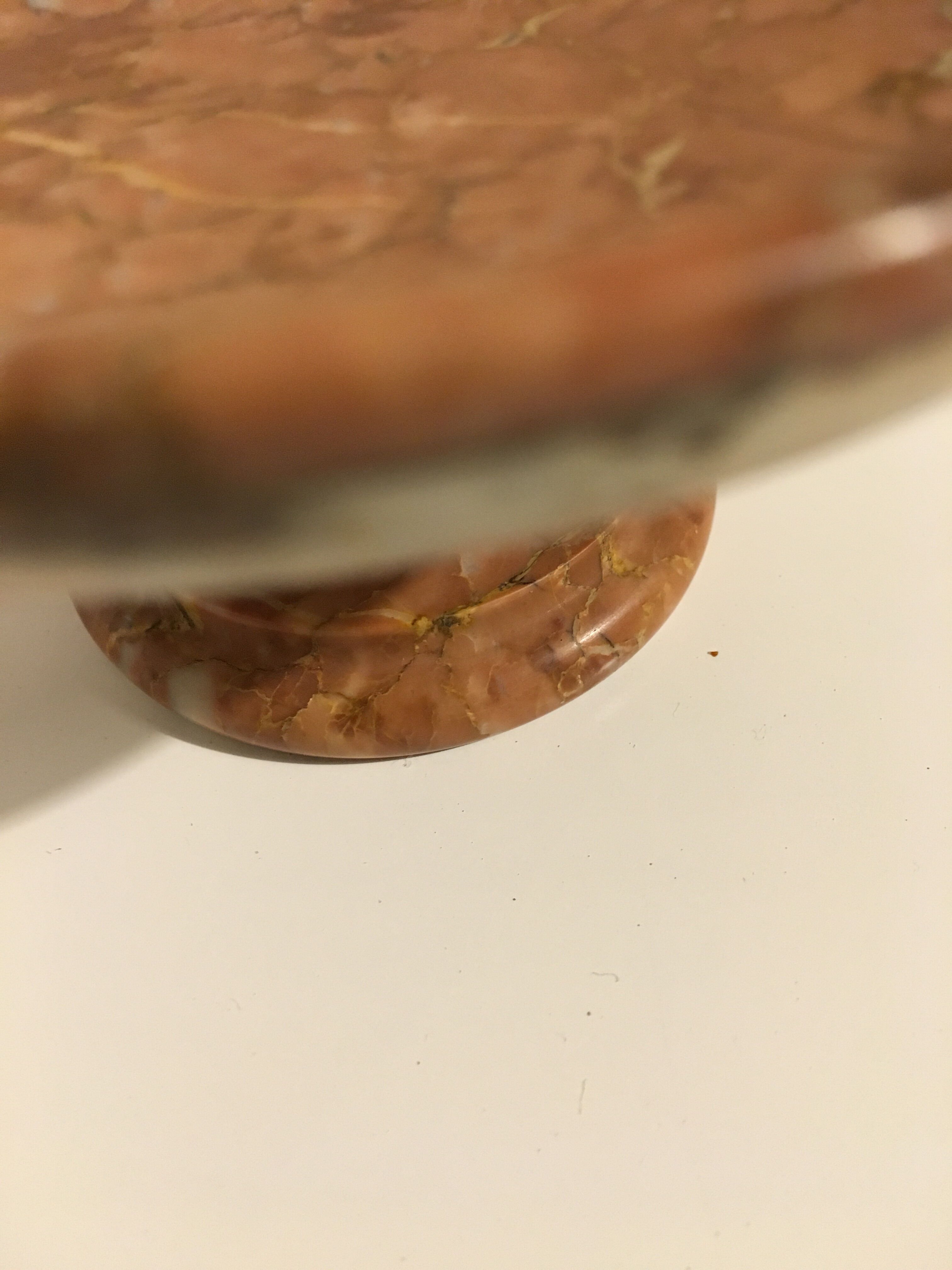 Empty pocket on foot in red marble