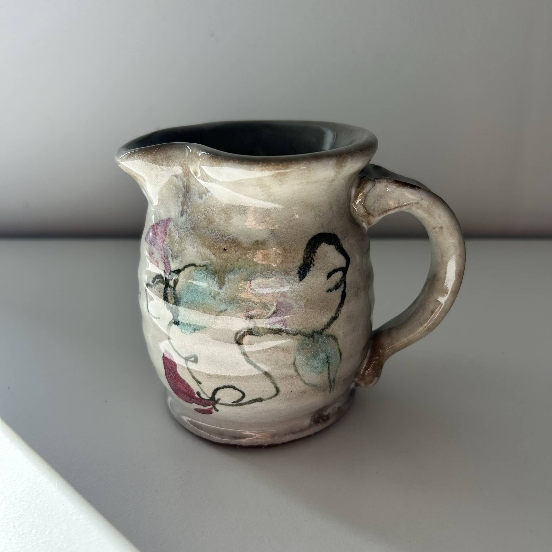 Floral decorated pitcher signed