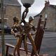Art Deco desk lamp in gilded bronze with a white glass globe, featuring dancer figurines.