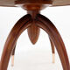 Round Art Deco side table in wood with curved legs and brass feet.