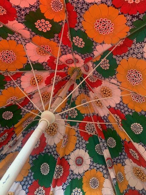 Large floral tilting beach umbrella with cotton fringes, 1960
