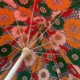 Large floral tilting beach umbrella with cotton fringes, 1960