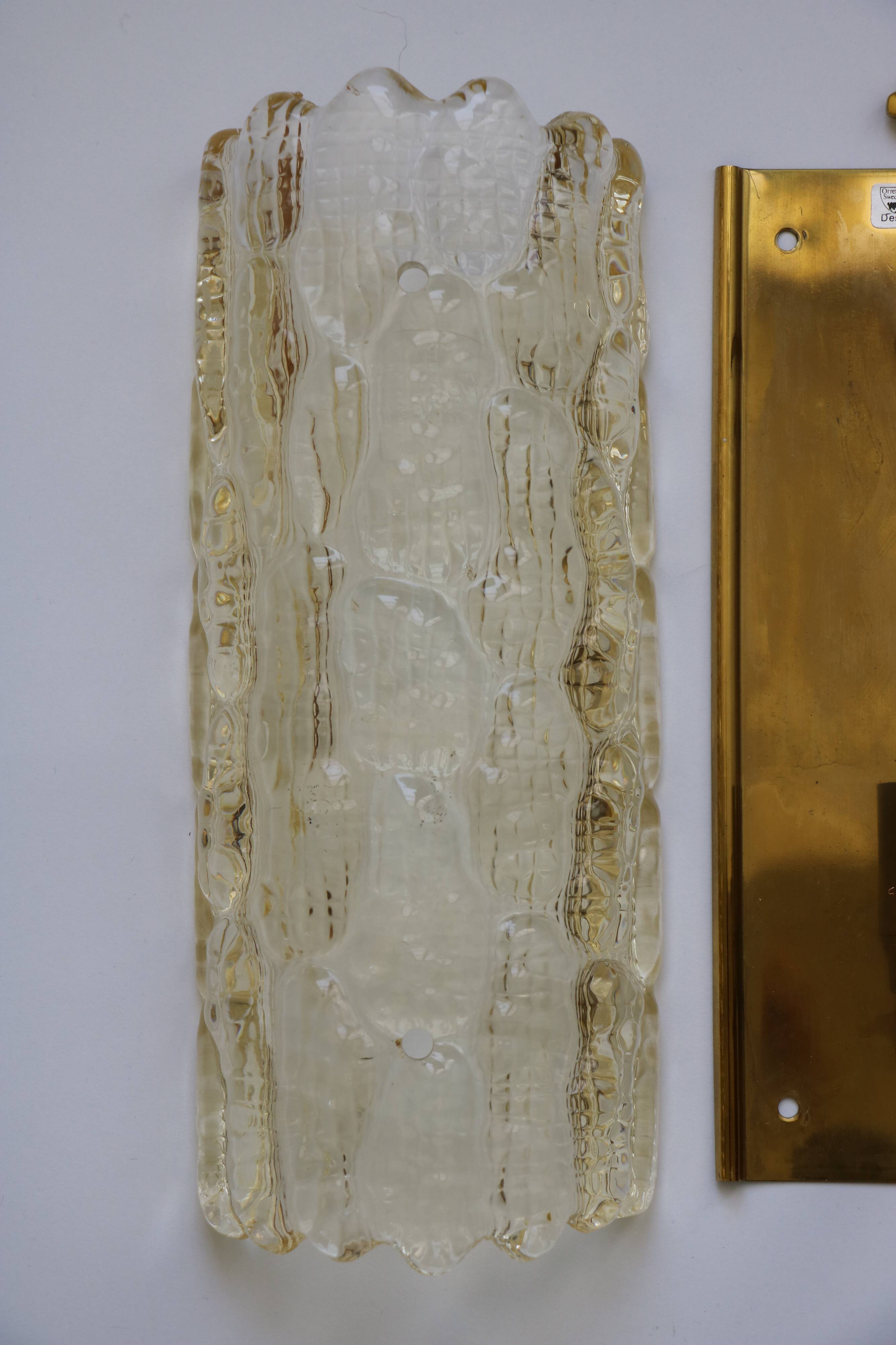 Pair of glass and brass wall lights by Carl Fagerlund for Orrefors, 1960.