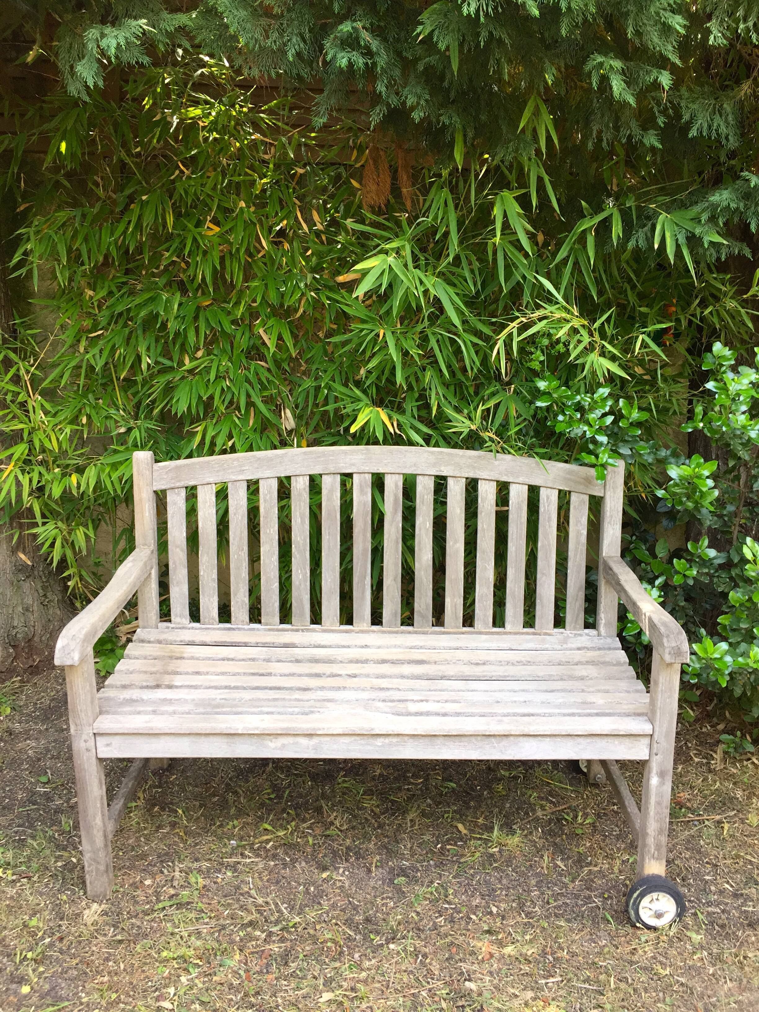 Vintage wooden garden bench with wheels