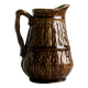 Pot à lait en céramique marron.