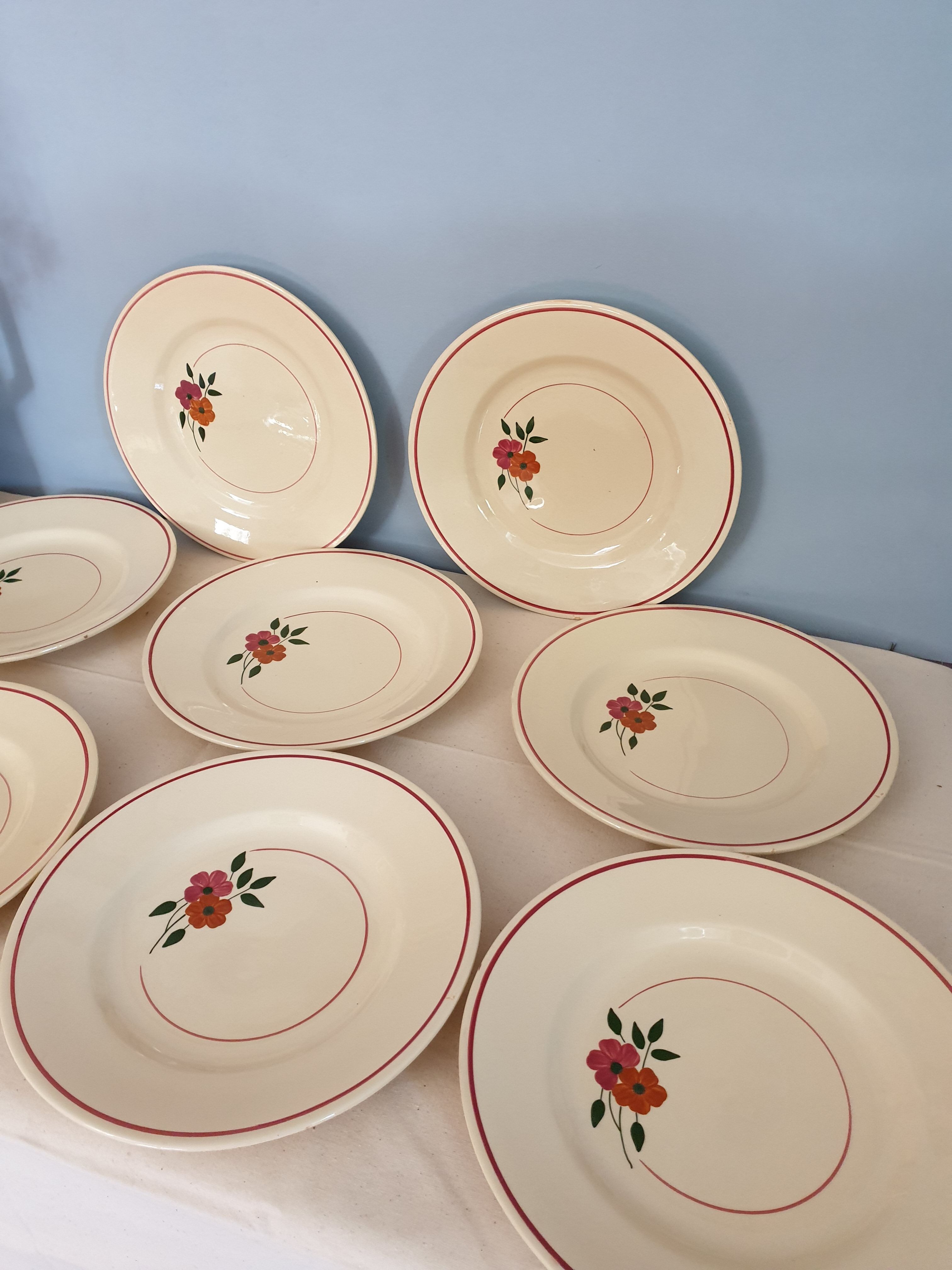Set of 11 hand-painted earthenware plates