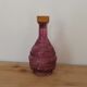 Vintage pink pressed glass carafe – retro decorative bottle with wooden stopper.
