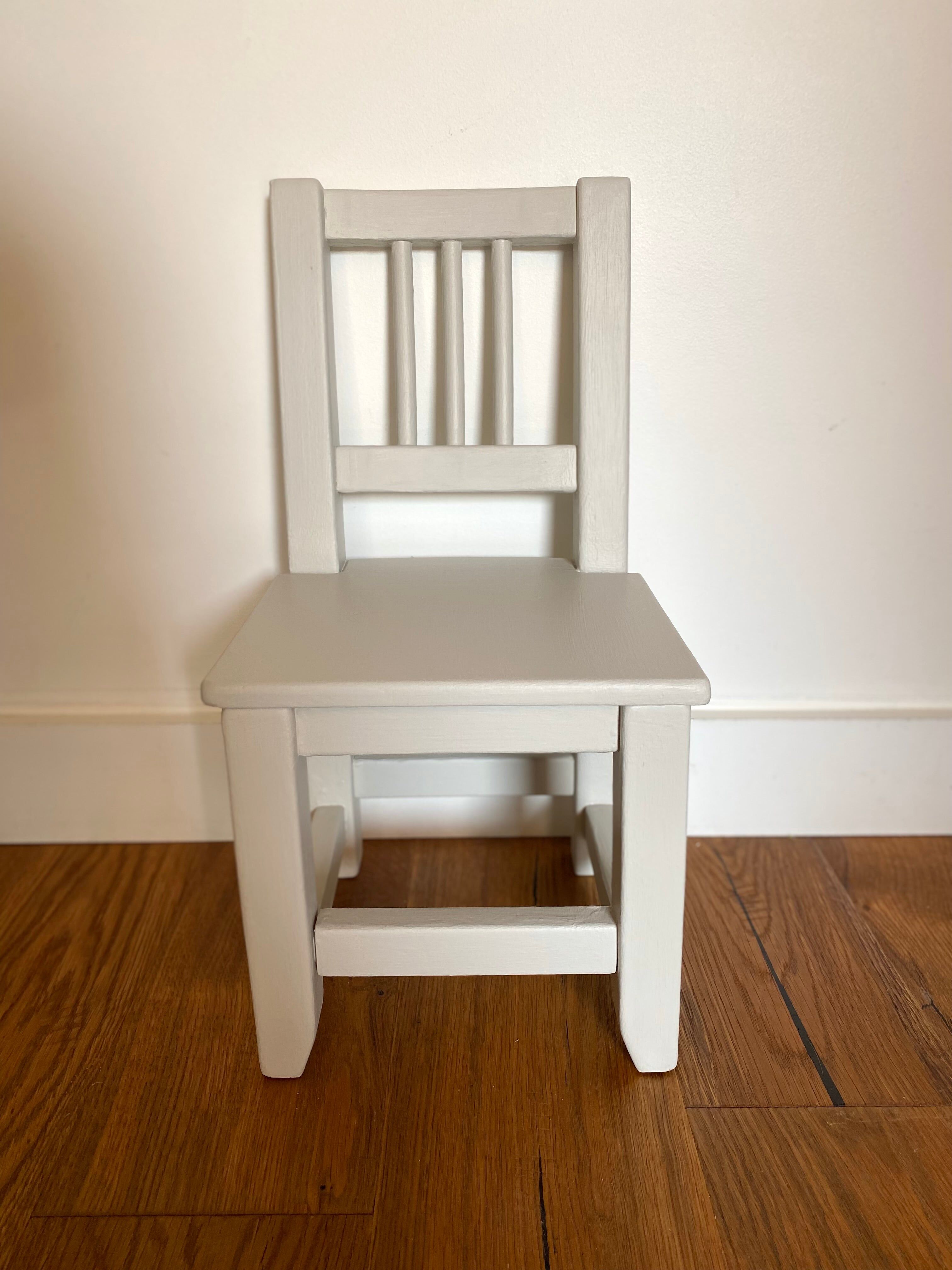 Small children's chair in antique white wood.