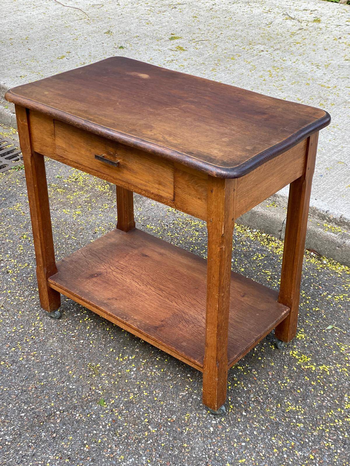 Vintage farmhouse dessert trolley on wheels made of solid wood from the 19th century.