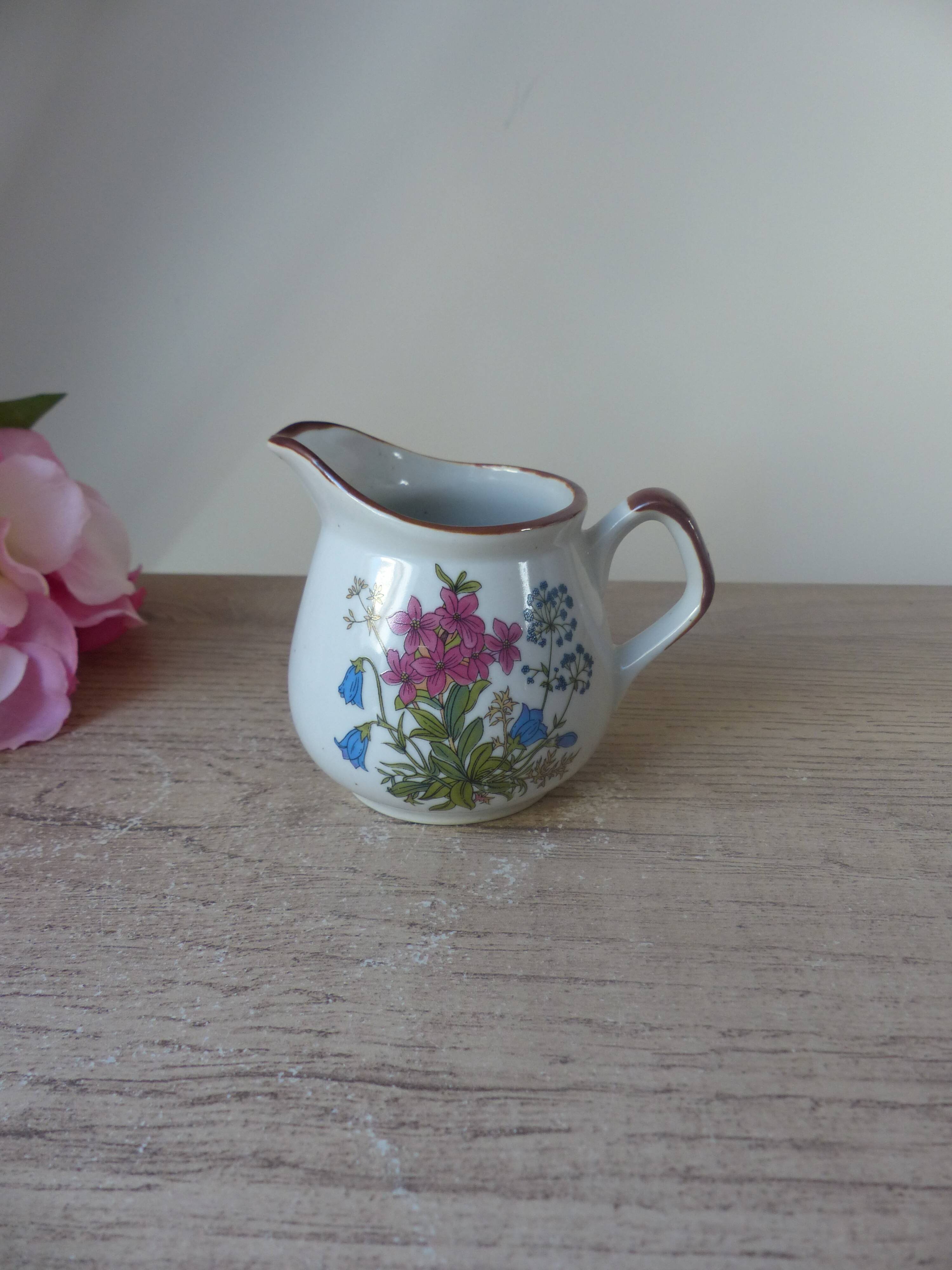 Old small artisanal milk jug in flowered speckled stoneware from the 1980s