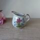 Vintage handmade speckled stoneware milk jug with floral design from the 1980s.