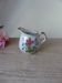 Vintage handmade speckled stoneware milk jug with floral design from the 1980s.