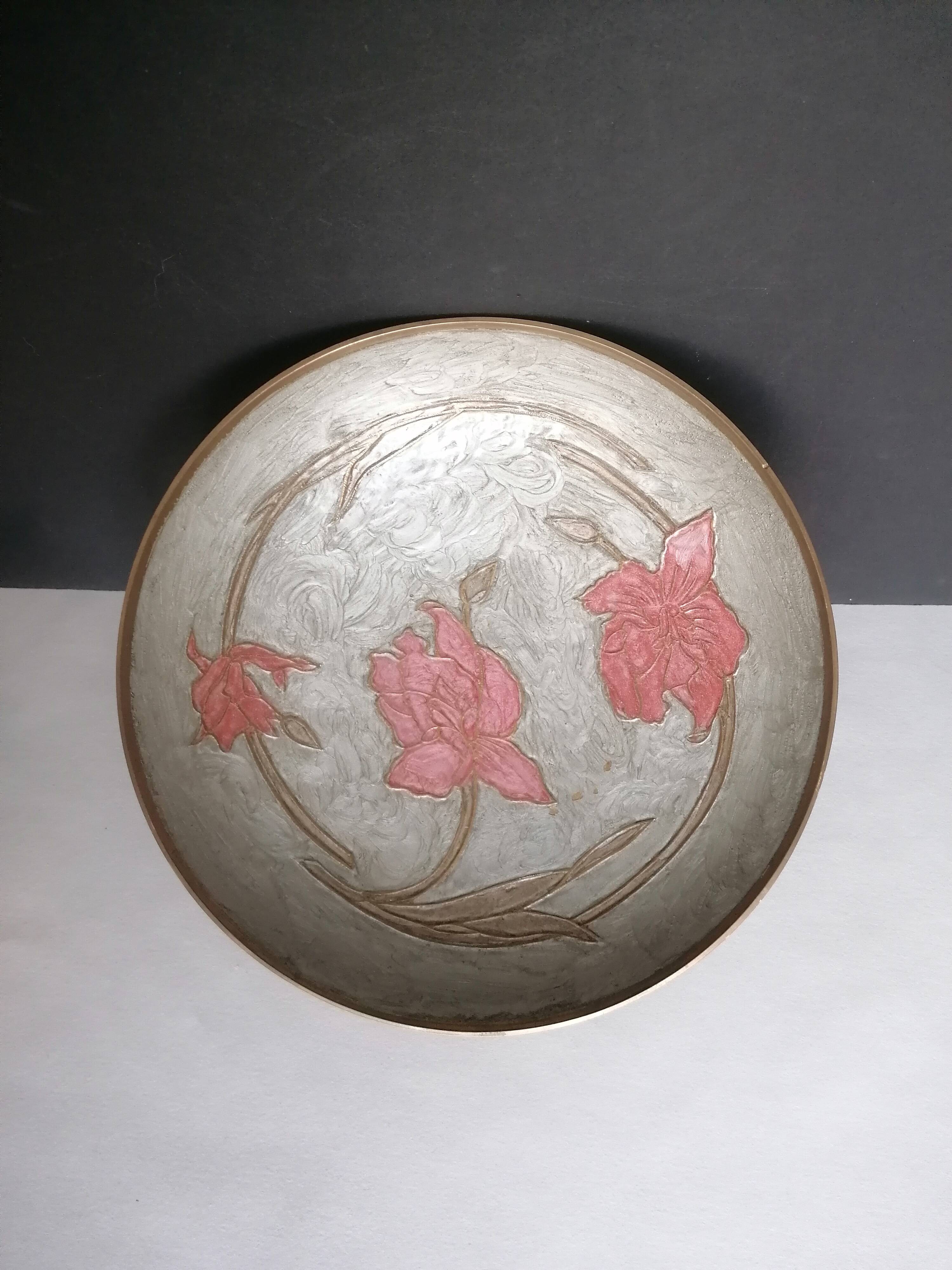 Enamelled brass stand with floral decoration.