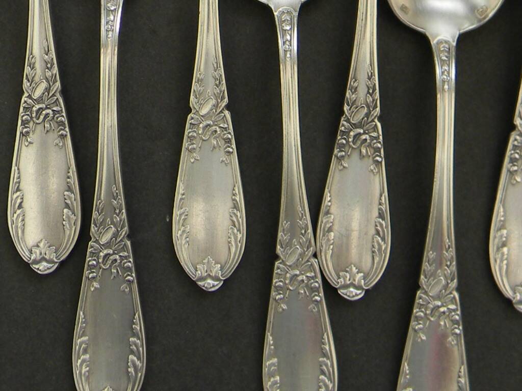 Set of 11 SFAM silver metal teaspoons.