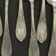 Set of 11 SFAM silver metal teaspoons.