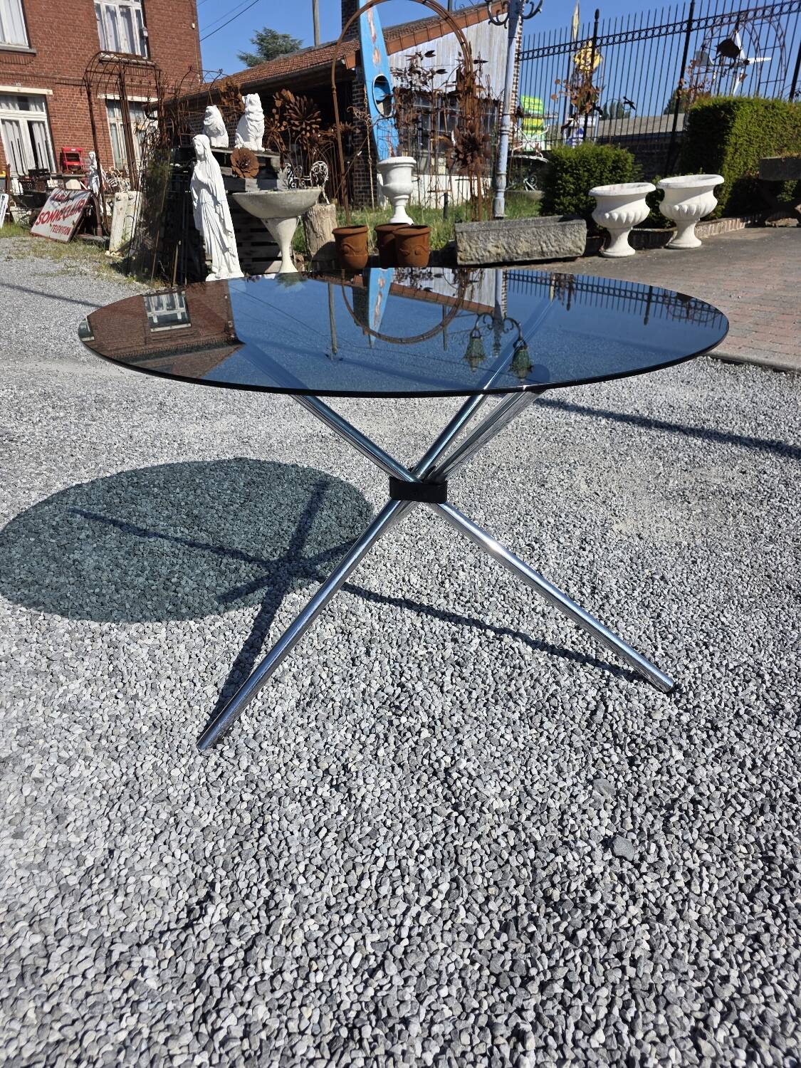 Round chrome metal table with smoked glass top from the 70s