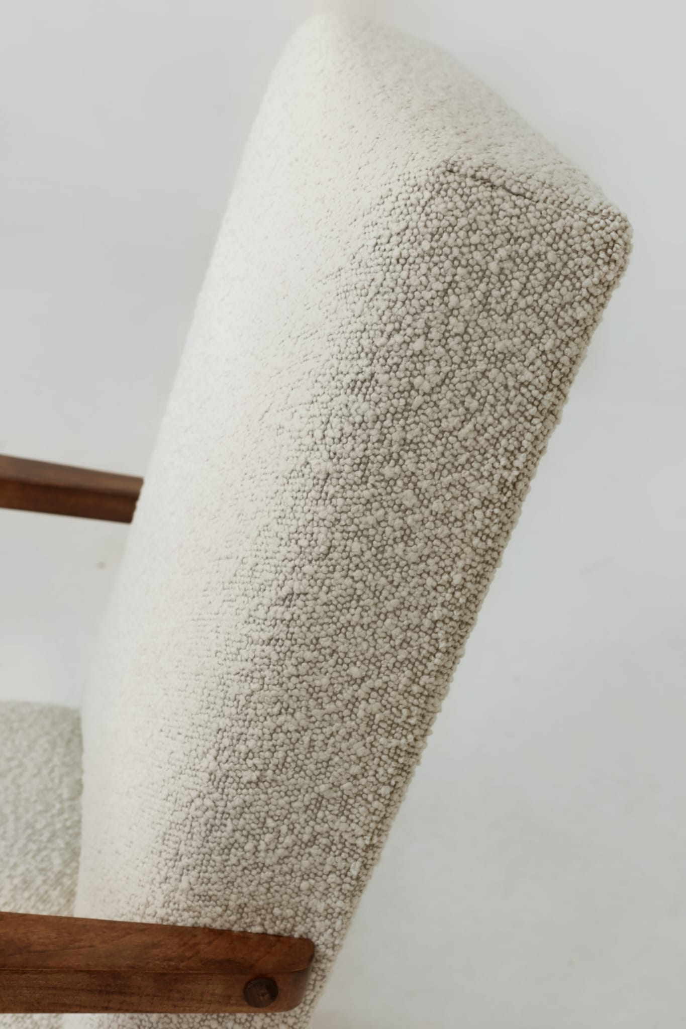 Pair of Mid-Century Modern armchairs in solid beech and boucle fabric.